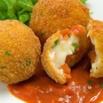 Golden Cheese-Stuffed Arancini Paired with Tangy Marinara